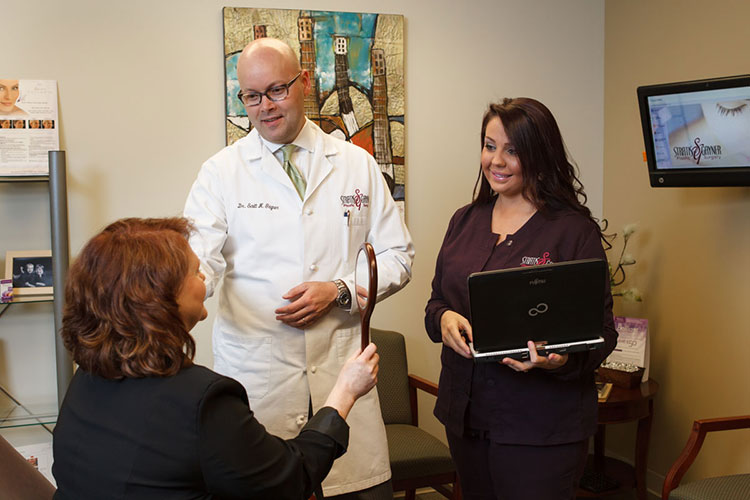 Staff Discussion with Patient Holding Mirror