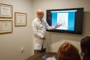 Doctor Giving Explanation of Content on TV Screen