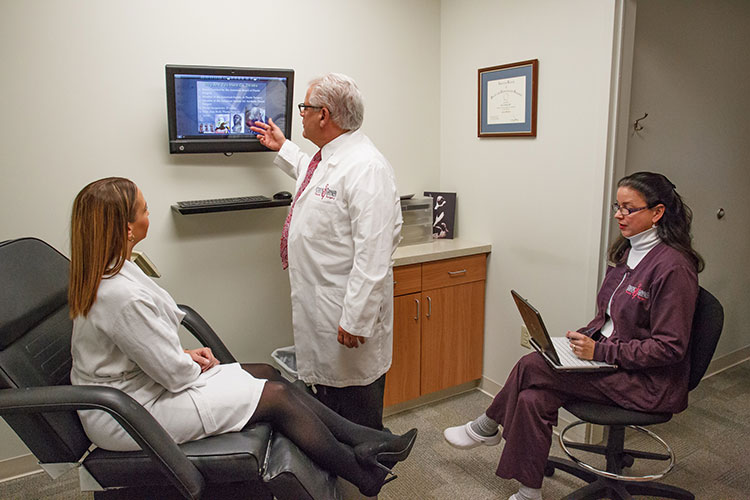 Doctor Explaining TV Content to Staff